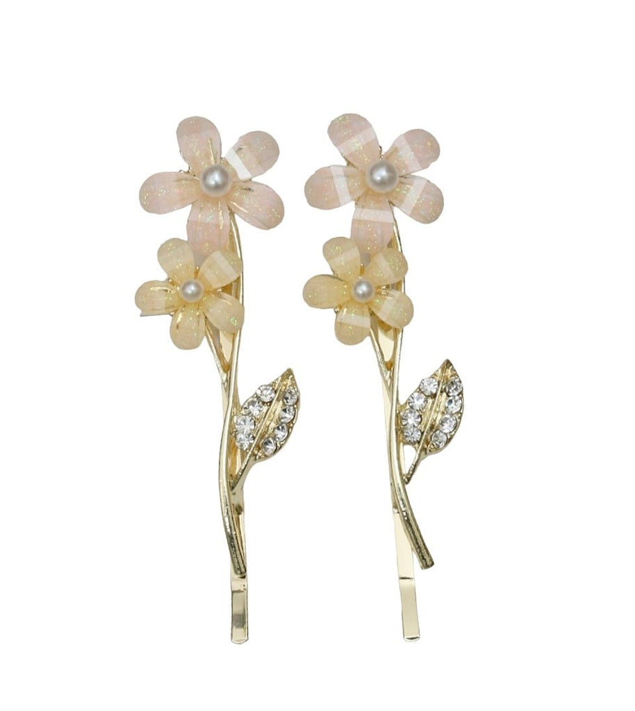 Decorative acrylic flower hairband and rhinestone leaf clips for kids, in a warm golden tone with peach accents.