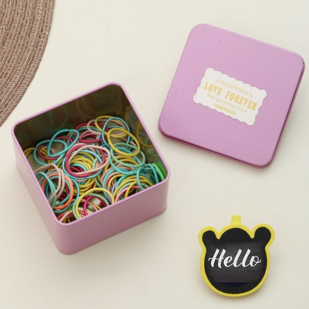 Creative presentation of Yellow Bee multi-coloured rubber bands, with a playful 'Hello' sign, symbolizing fun hair styling.