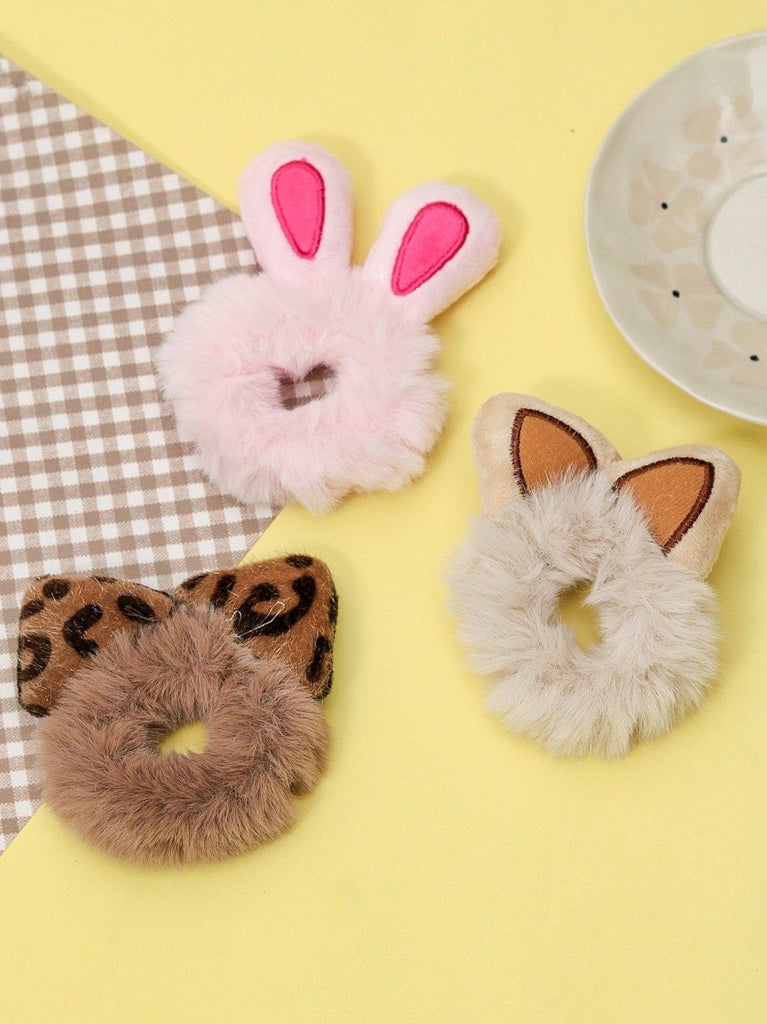 A playful set of Yellow Bee fur scrunchies with bunny, leopard, and cat ears on a vibrant background.