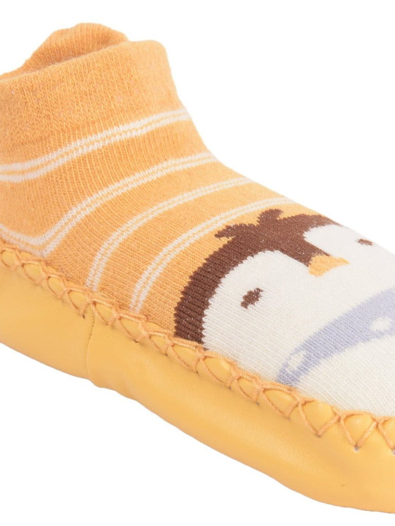 Close-up view of the penguin face on yellow sock shoes with soft fabric upper.