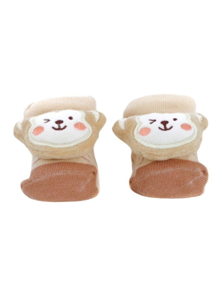 Front view of beige baby booties with a 3D monkey face design, providing warmth and comfort.