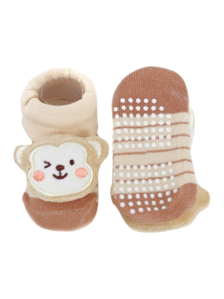 Front and back view of beige baby booties featuring an adorable 3D monkey face, perfect for infants.