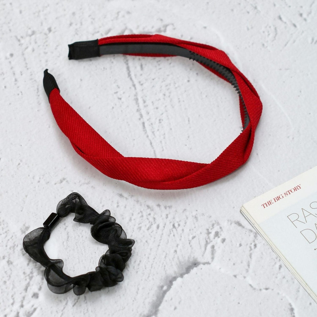 Yellow Bee's red hairband and black scrunchie styled with a book for a lifestyle look.