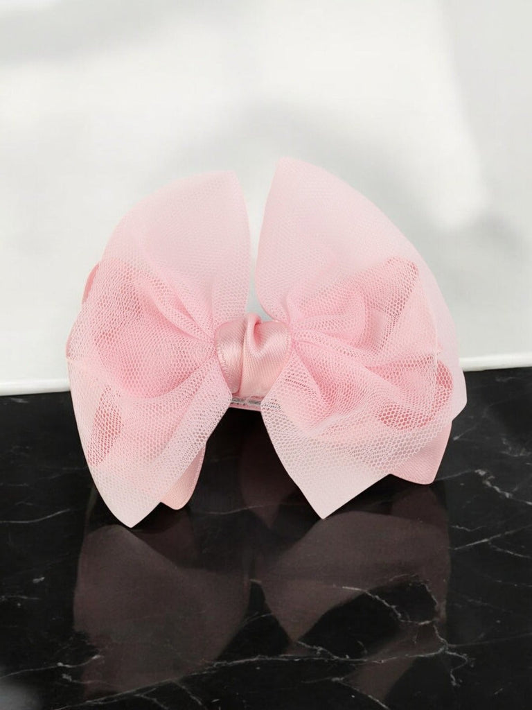 Creative view of Yellow Bee's Pink Bow Alligator Hair Clip, highlighting the delicate bow design.