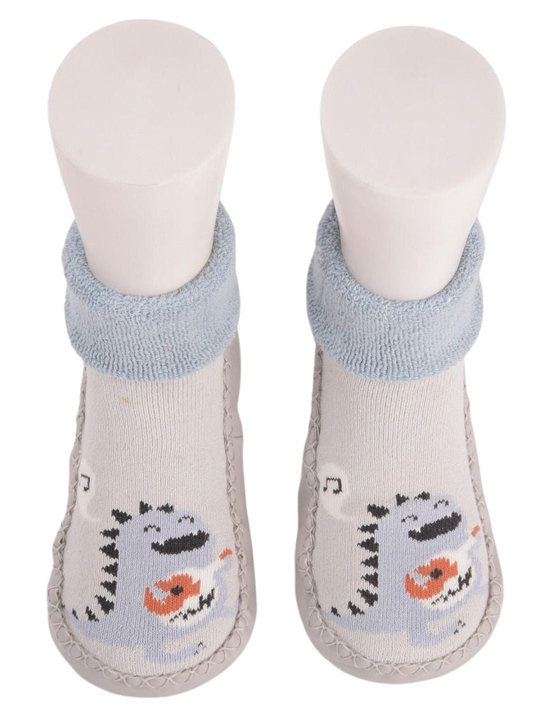 front view of Baby Dinosaur Face Moccasin Socks showing the cute dinosaur print.