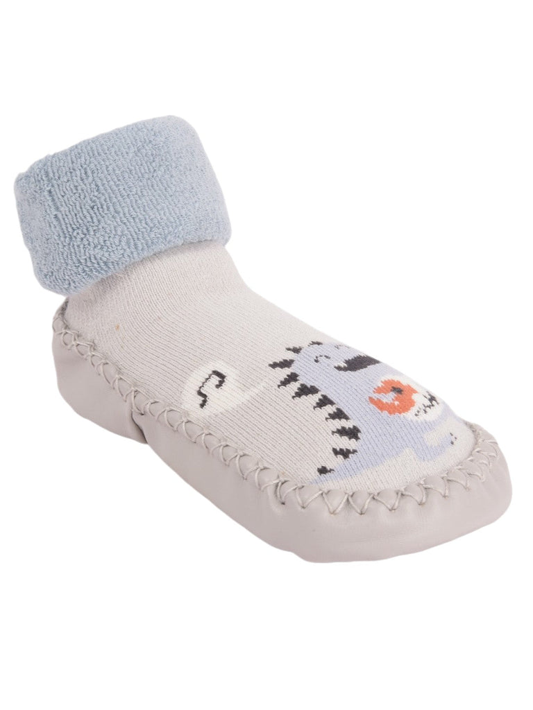 Angle view of Baby Dinosaur Face Moccasin Socks with soft grey and blue design.