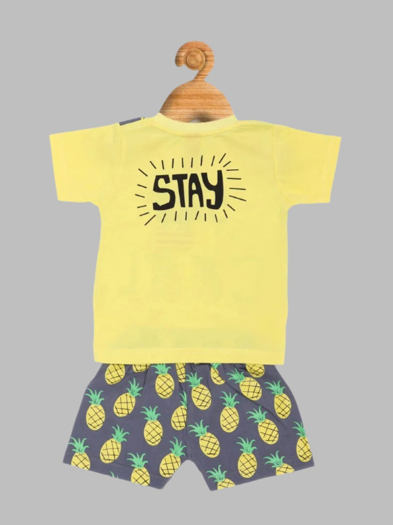  Back view of Jaybee boy’s pineapple print t-shirt with "Stay" graphic on yellow fabric.