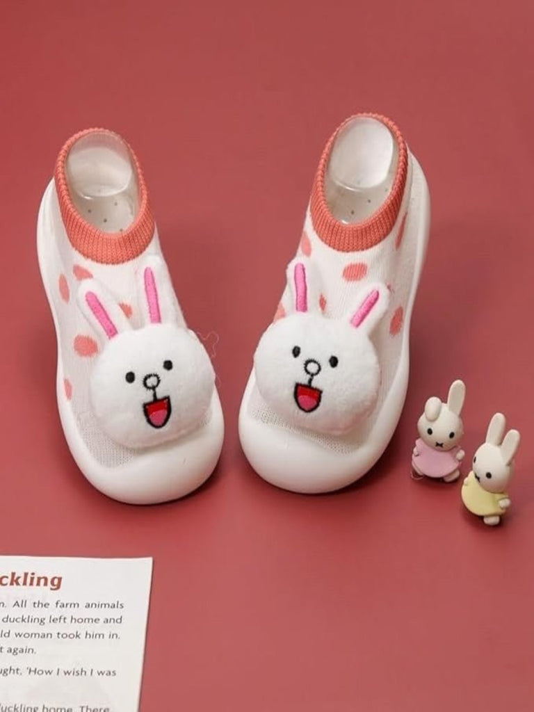 Creative view of Yellow Bee Bunny Stuffed Toy Anti-Skid Rubber Sole Shoe Socks for Girls on a pink background with bunny toys.