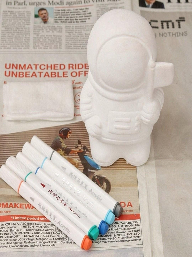 Astronaut, including ceramic astronaut figure and acrylic markers.