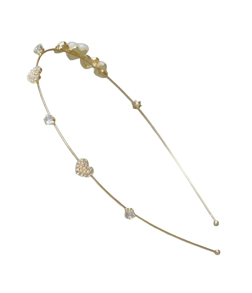 Display of Yellow Bee's golden hairband with heart design, showcasing the intricate rhinestone details and acrylic finish.