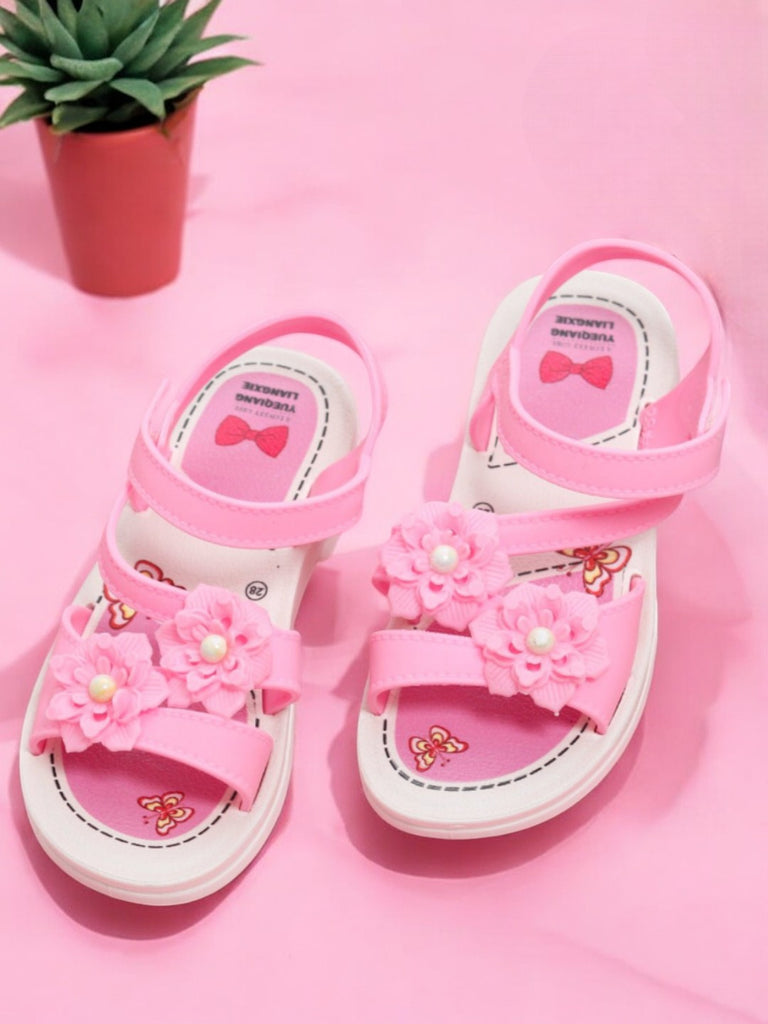 Toddler's pink sandals with flower embellishments and bow insole design.