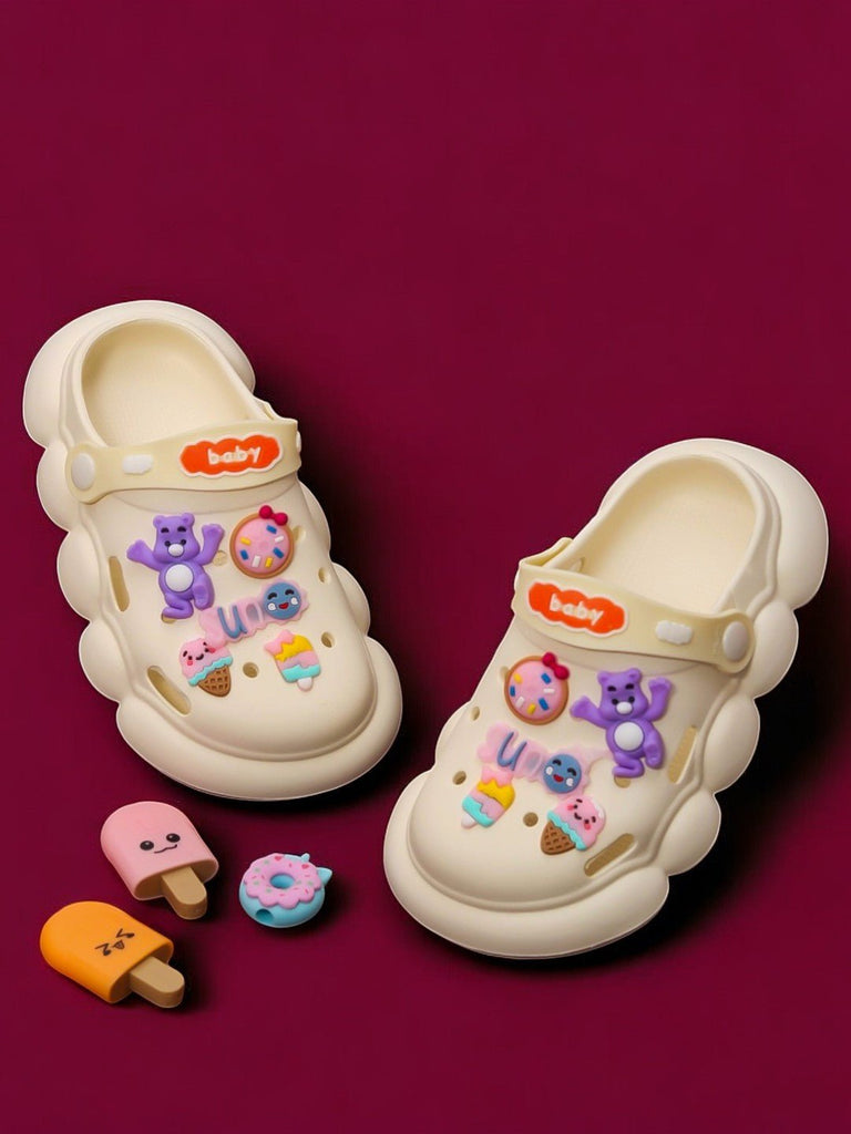 Kid's Fantasy Clogs with colorful bear and sweet treats charms on a beige background.