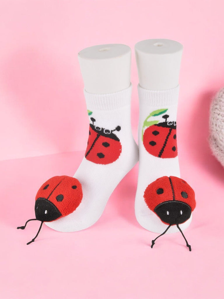 Pair of white ladybug toddler socks with non-slip bottom