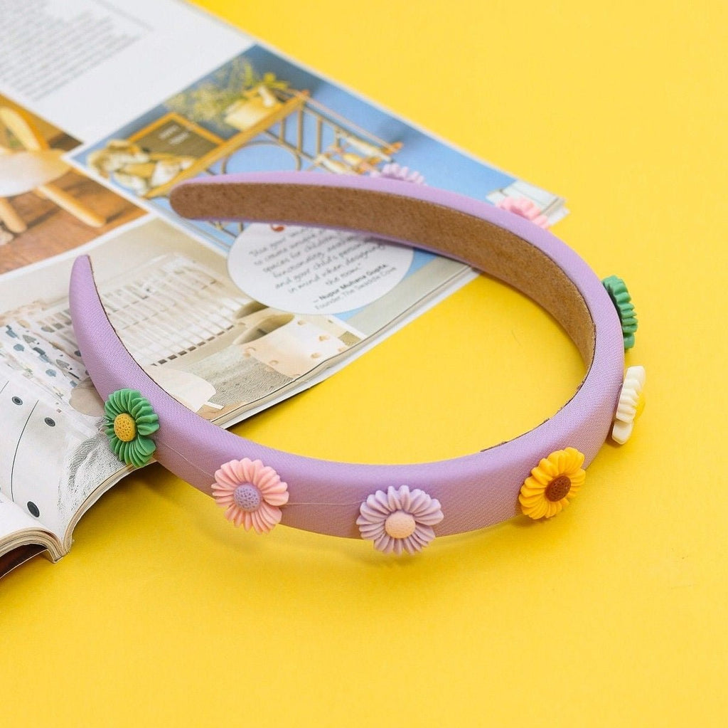 Creative shot of Yellow Bee's Purple Hair Band with Flower Embellishments for Girls