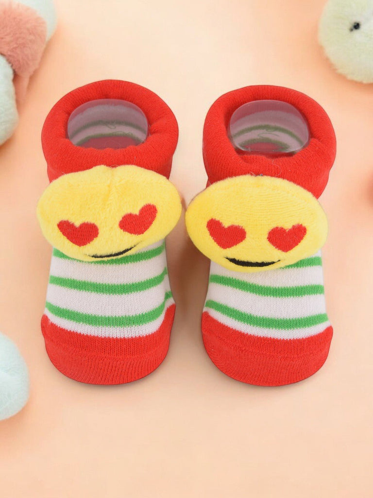 Yellow smiling emoji fuzzy socks with love-struck eyes and cheerful striped design