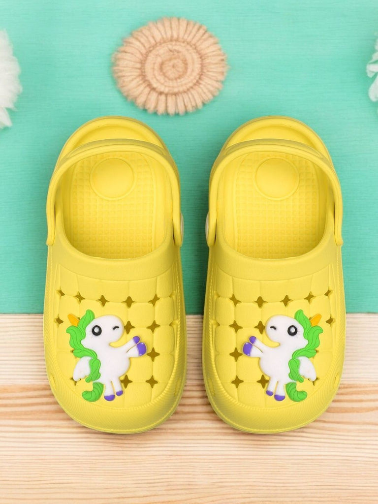 Vibrant yellow children's clogs adorned with a playful unicorn charm, perfect for imaginative play.