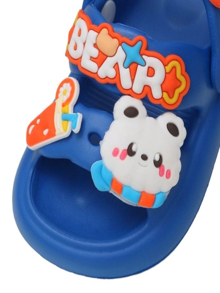 close up view of durable blue slide sandals with cloud and beverage charms for children.