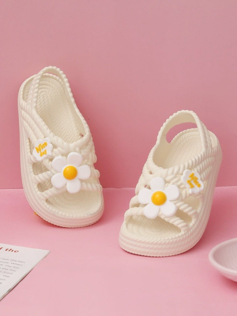 Creative display of Yellow Bee Children's Sandals with Flower Charms, perfect for a playful wardrobe addition