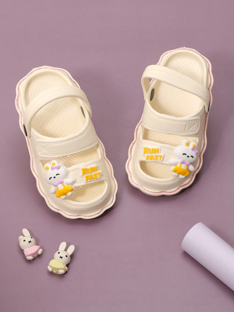 Creative display of Yellow Bee's Bunny Bliss sport sandals in a playful cream setting.