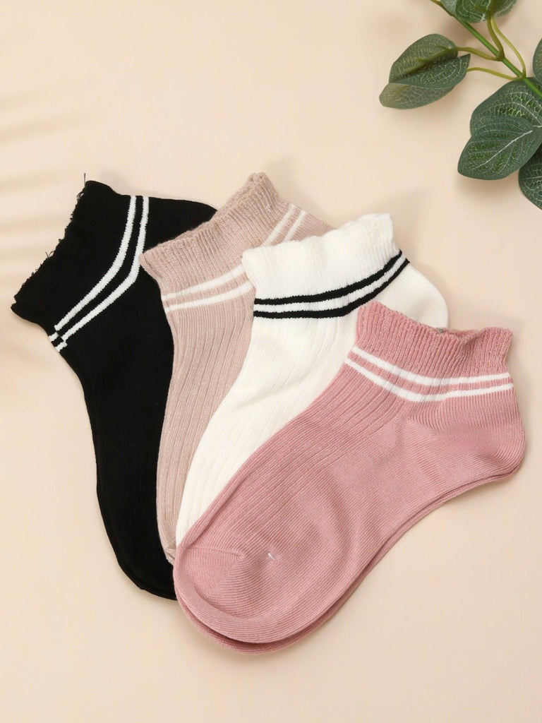 Four pairs of ankle socks in neutral tones – black, beige, white, and pink – with striped details, displayed on a light background.
