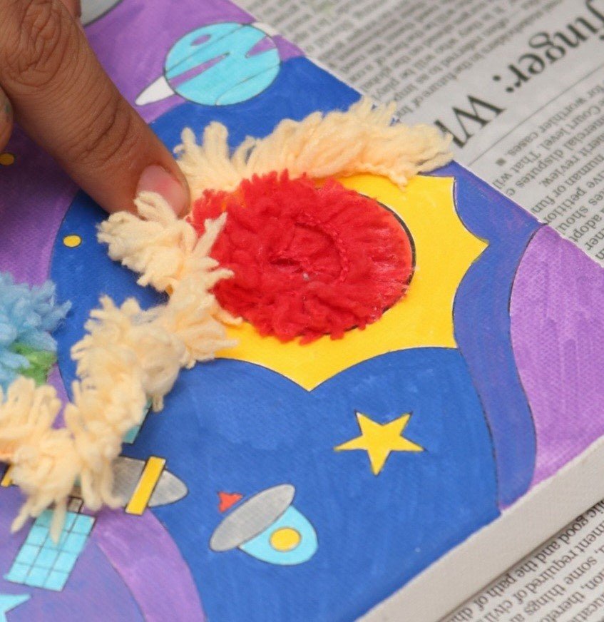 Detailed view of art materials in the Yellow Bee Cosmic Adventure DIY Astronaut Art Kit.