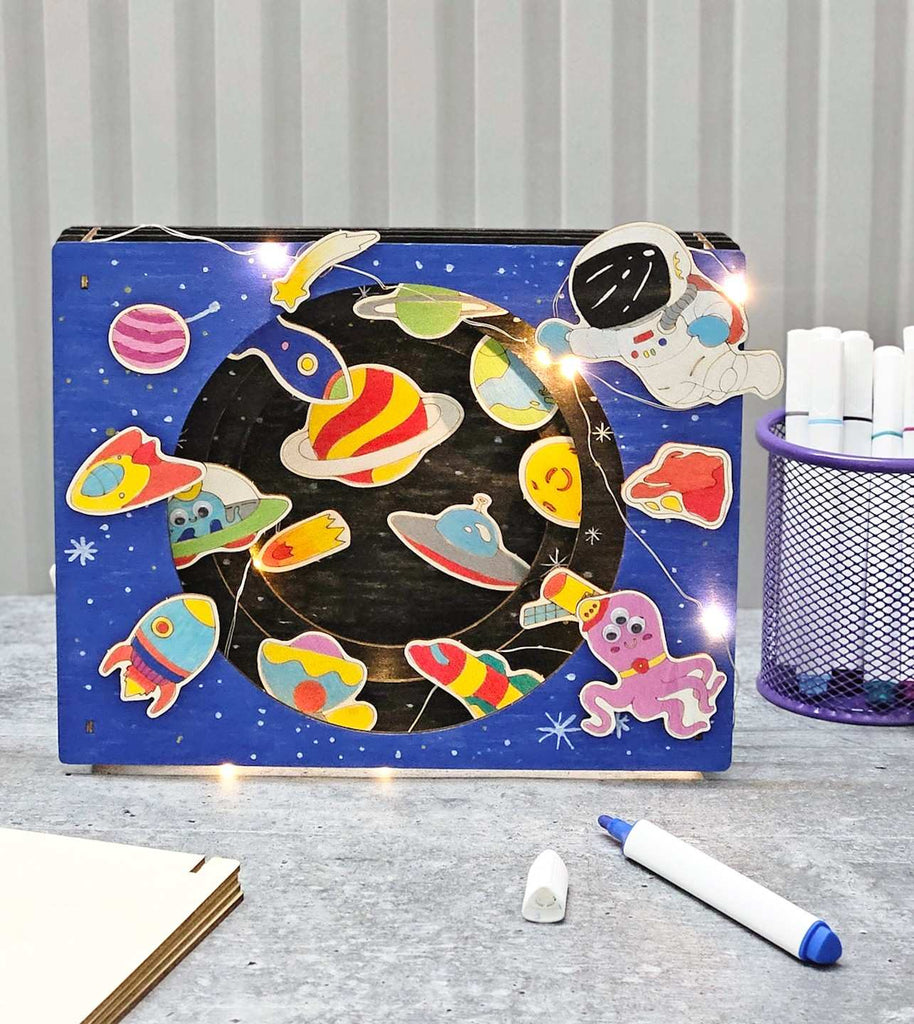 Creative setup displaying the fully assembled Cosmic Explorers DIY 3D Light Box Kit by Yellow Bee.