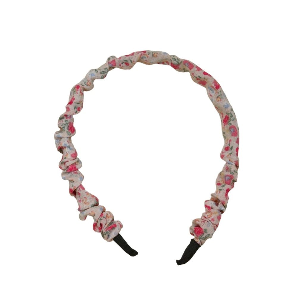 Close-up of the crinkled floral hairband by Yellow Bee, showcasing the detailed pink and purple design.
