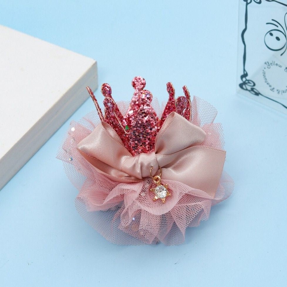 Yellow Bee's Pink Crown Hair Clip displayed on a pastel background, emphasizing its playful and festive design.