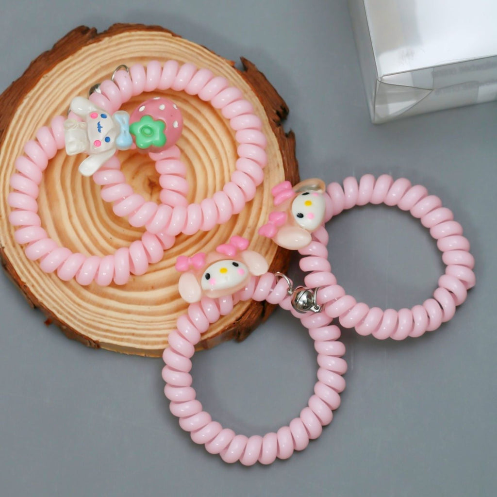 Close-up of Yellow Bee's pink spiral rubber bands with cute cartoon pendants and a practical magnet, arranged beautifully for display.