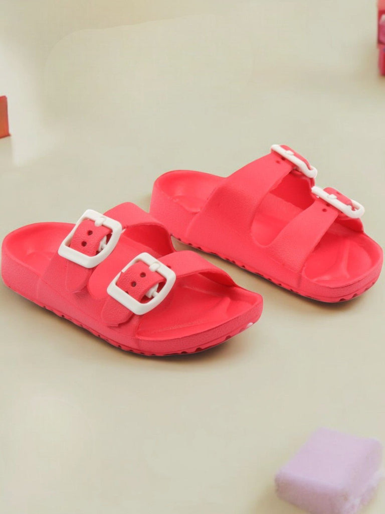 Creative view of Double Buckle Slides for Boys in Red on a wooden background.