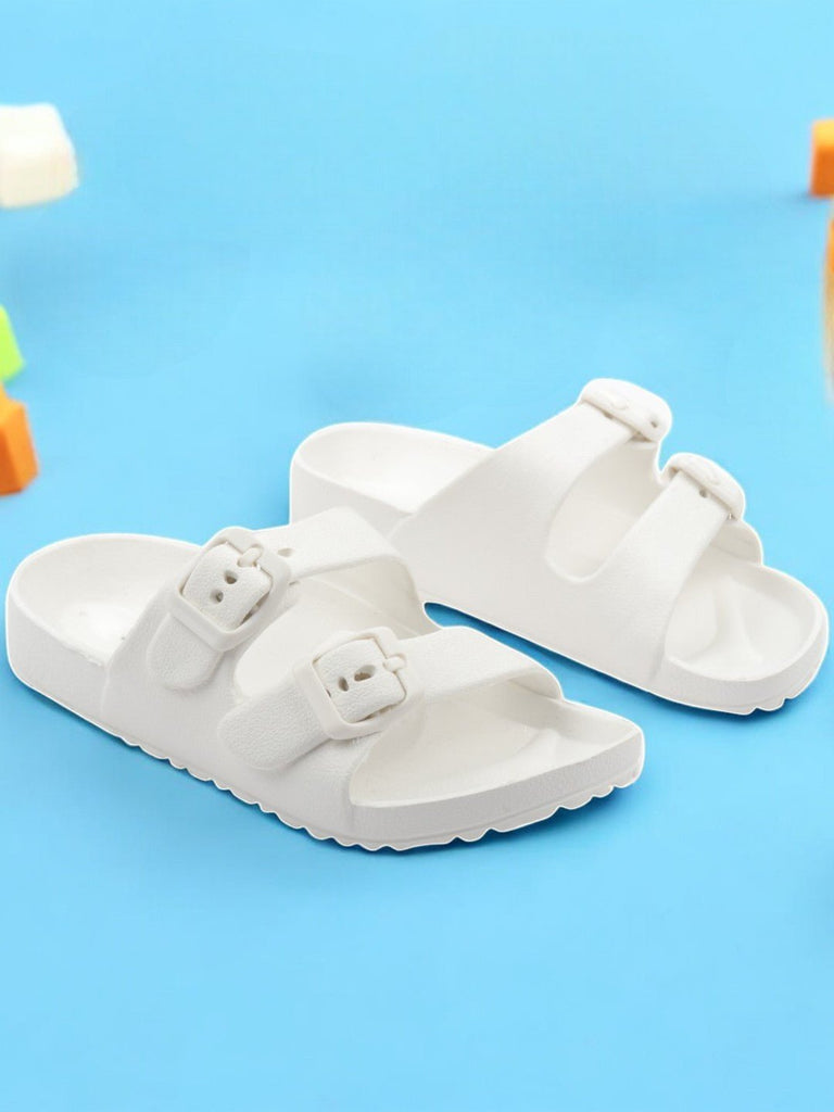 Creative view of Double Buckle Slides for Boys in White placed on a wooden background.