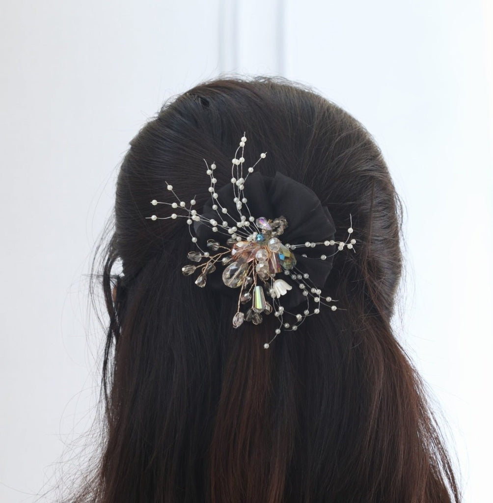 A model showcasing Yellow Bee's black headdress flower hair clip, demonstrating its alluring charm and secure fit.