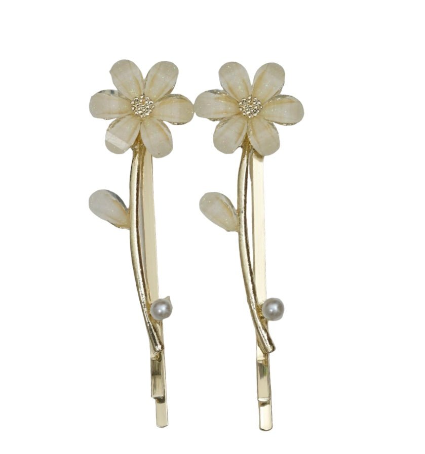 Yellow Bee's white acrylic flower hair clip with rhinestone embellishment on a golden stem.