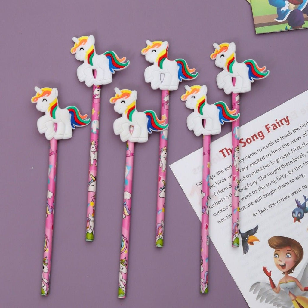Group of Yellow Bee's multi-colored pencils with unicorn toppers spread on a purple background.