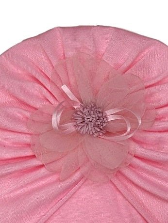Close-up view of the intricate flower embellishment on Yellow Bee's baby girl turban in light pink