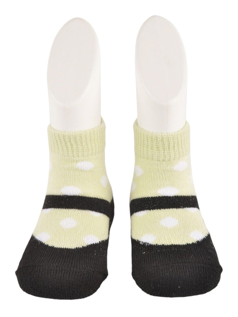 Detailed front view of baby’s black and yellow polka dot socks with faux shoe design.