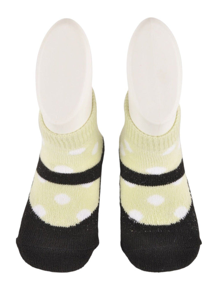 Detailed front view of baby’s black and yellow polka dot socks with faux shoe design.