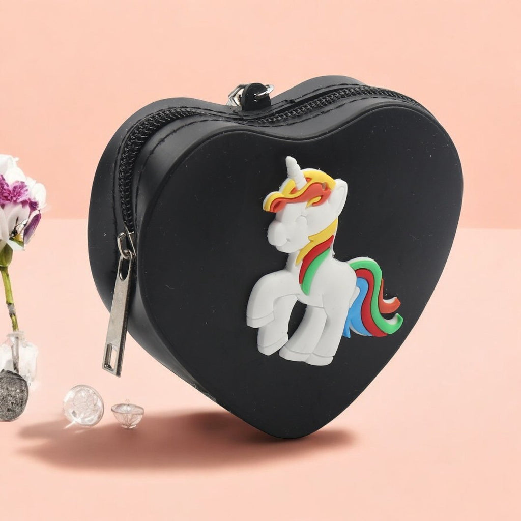 Heart-Shaped Black Coin Pouch with Colorful Unicorn Design in a creative view with a pastel pink background.