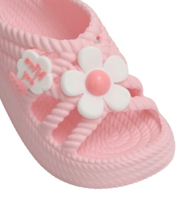Close-up of Yellow Bee's Pink Sandals with white floral detail, highlighting the vibrant color and applique design