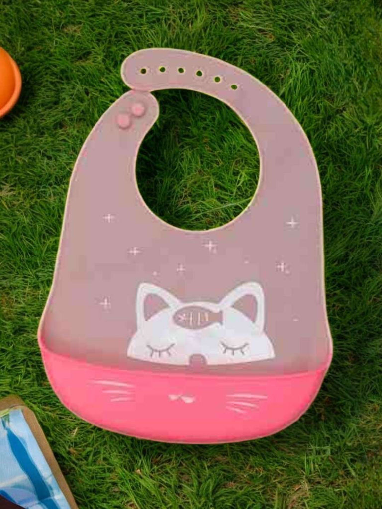 Creative display of Kitty Whiskers Silicone Baby Bib for Girls with pink color and cat design.