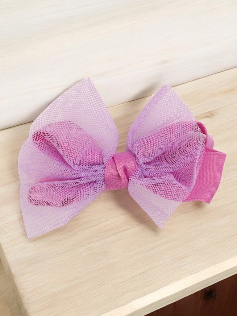 Creative view of the large tulle hair bow clip featuring a playful blend of lavender and pink hues by Yellow Bee.