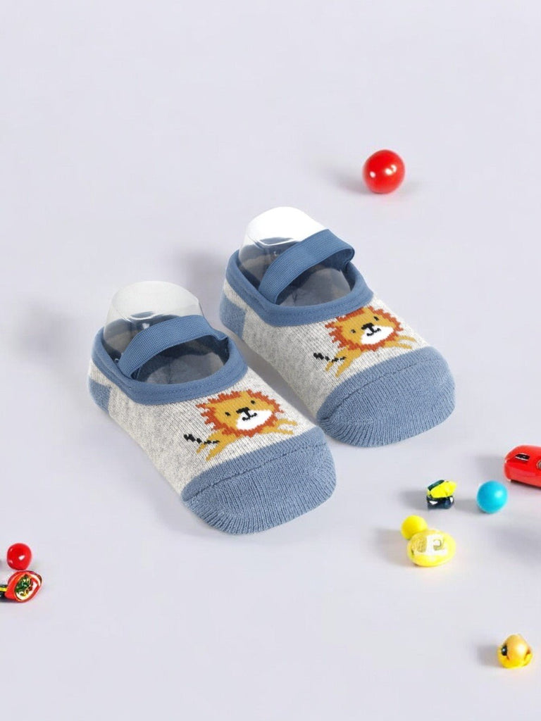 Baby socks featuring a lion print, showcasing their comfortable and snug design with a strap for added support.