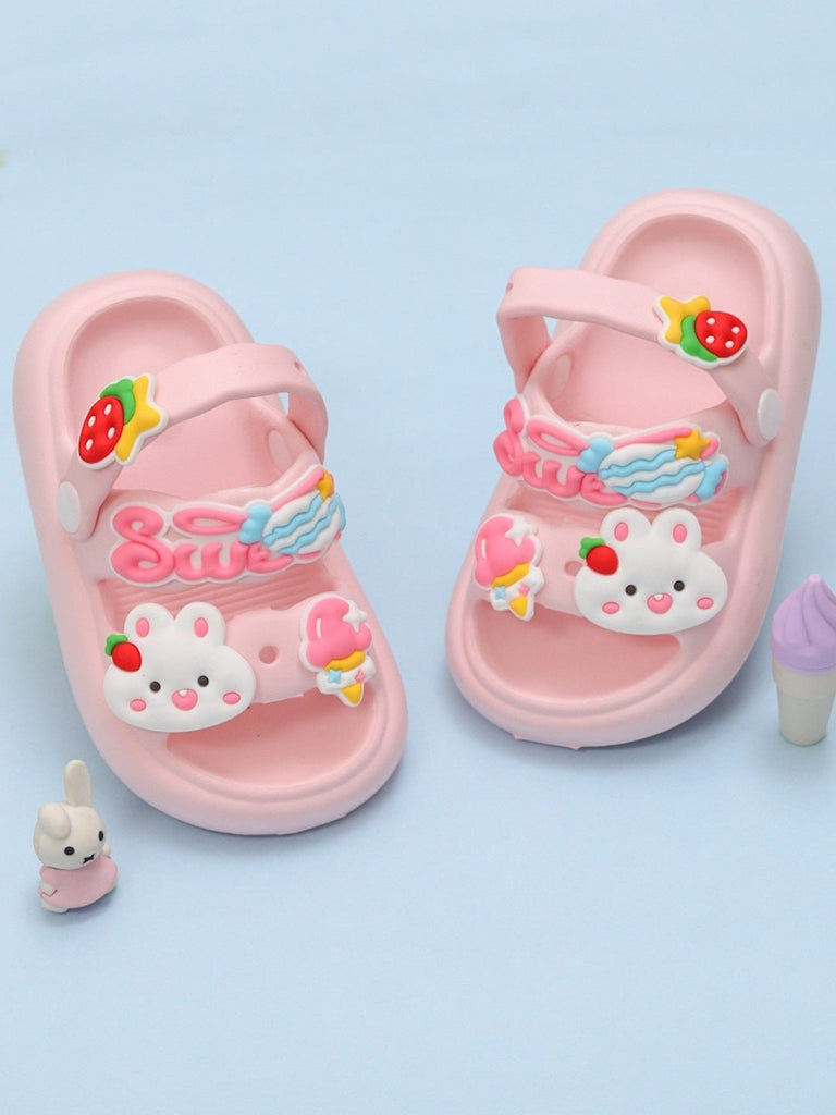 Creative display of pink  Girls' sandals with bunny and garden-themed charms.