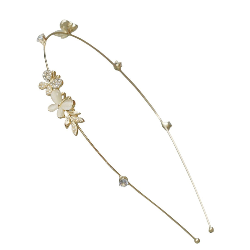 A close-up of Yellow Bee's golden hairband with white acrylic butterfly and flower details, showcasing the meticulous craftsmanship and elegant design.