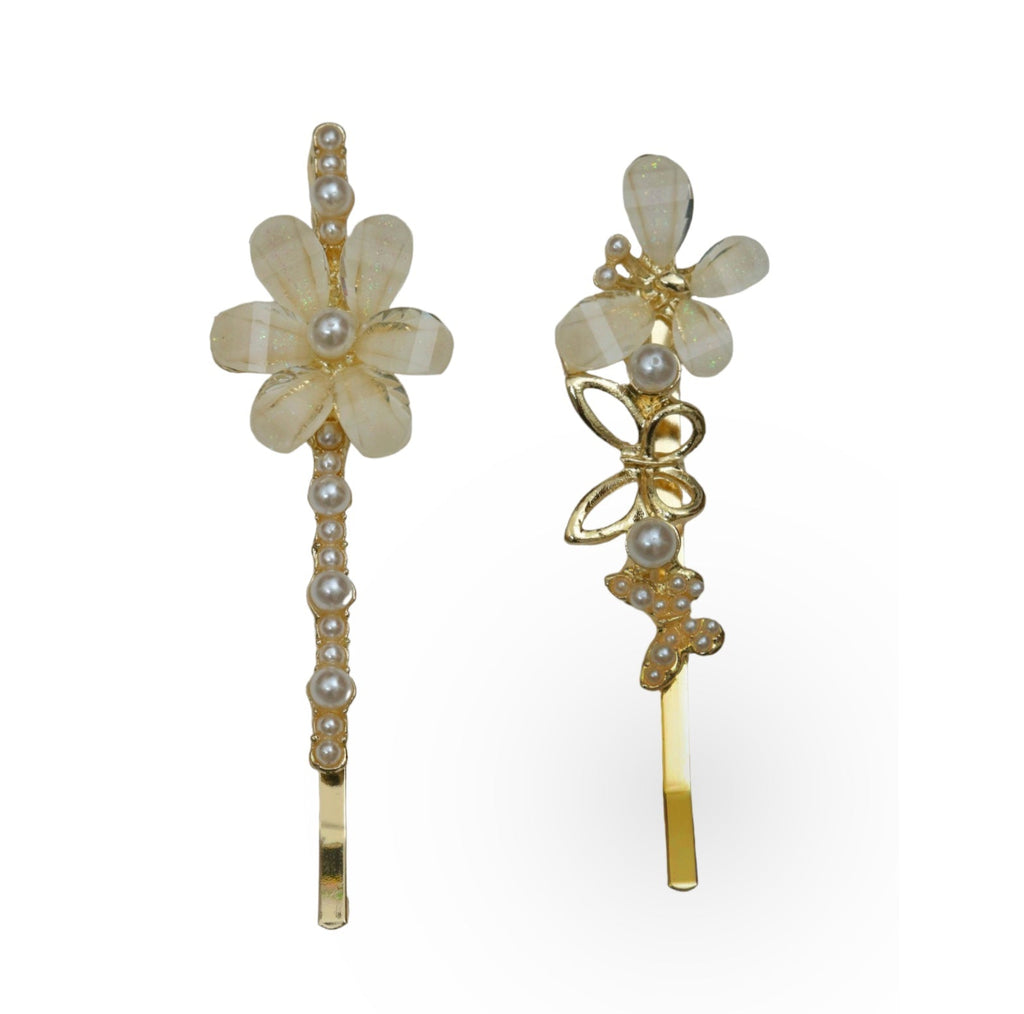 Two golden hair clips from Yellow Bee, each adorned with an intricate acrylic butterfly and flower design, isolated against a white backdrop for a clear, detailed view.