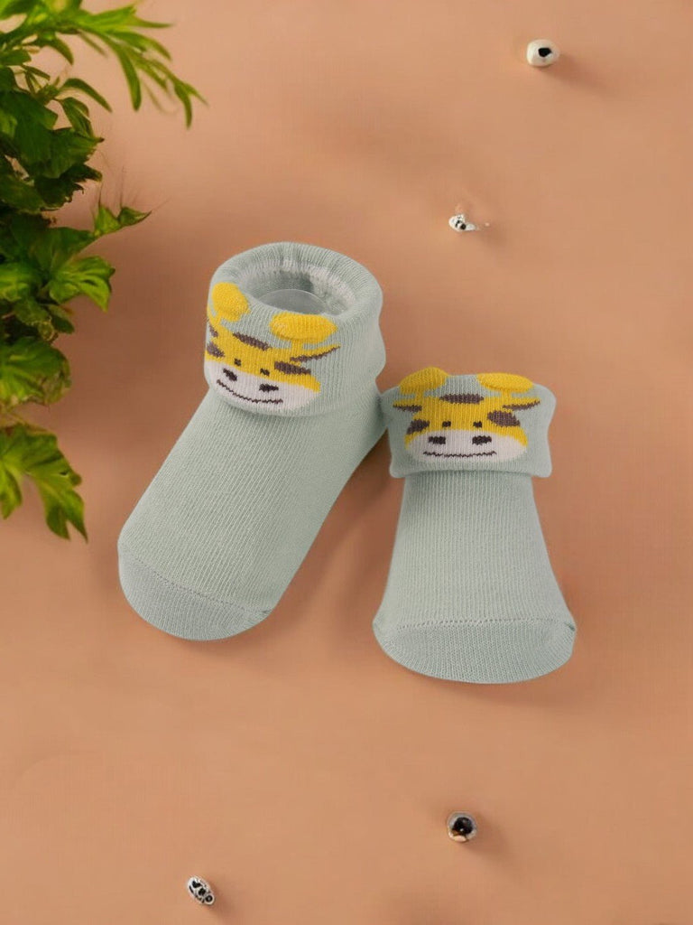 Creative view of Mint Green Baby Booties with 3D Giraffe Face, featuring the soft material and playful design.