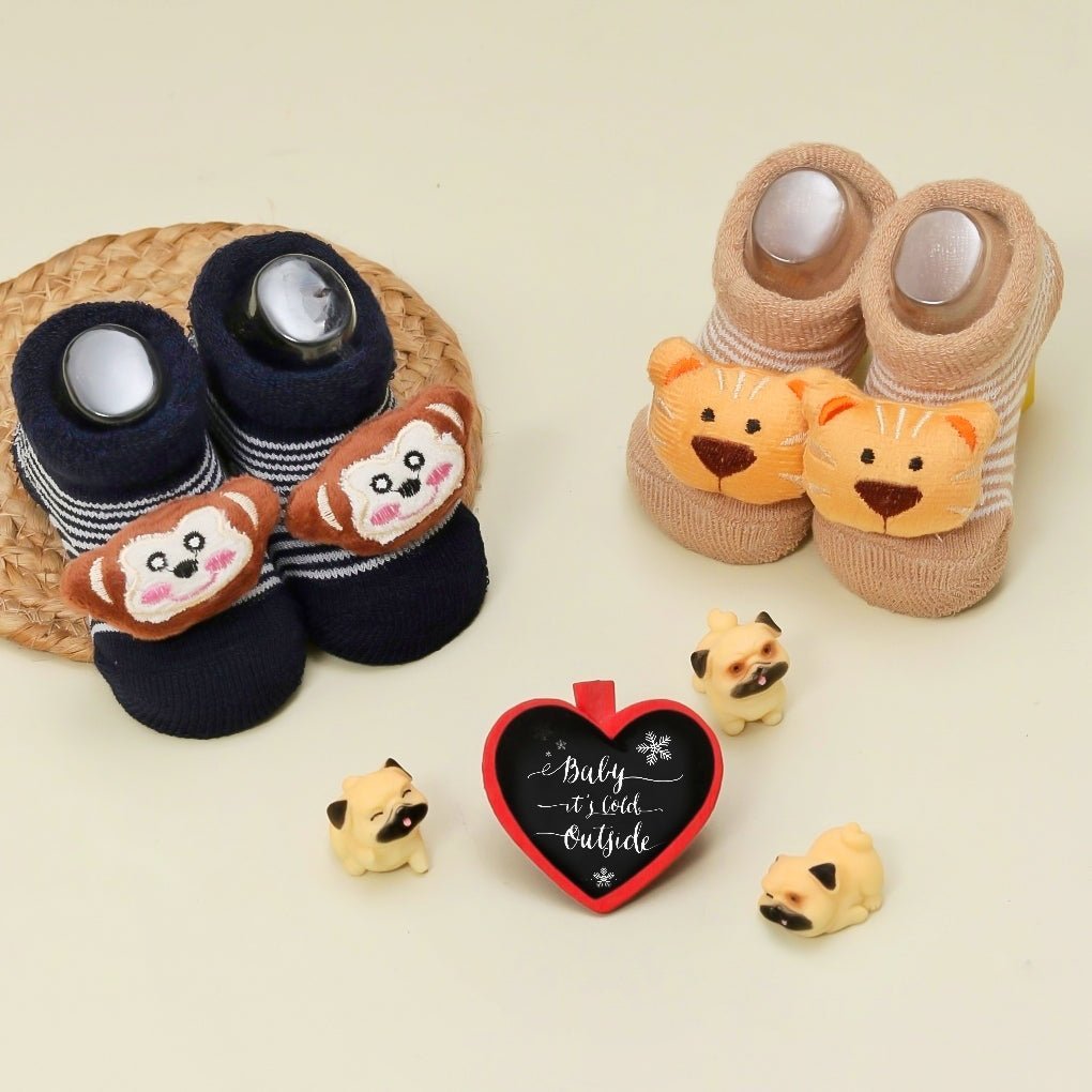 Display of Yellow Bee's navy and brown monkey and tiger stuffed toy socks for boys in a pack of two.