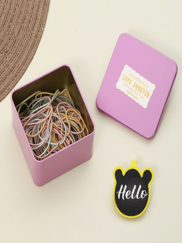 Creative presentation of Yellow Bee multi-coloured rubber bands, with a playful 'Hello' sign, symbolizing fun hair styling.