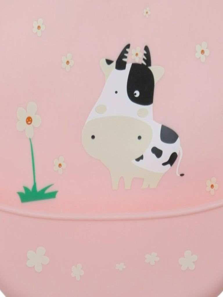 Detailed closeup of the cow and daisy design on the Pastel Daisy Cow Silicone Baby Bib for Girls