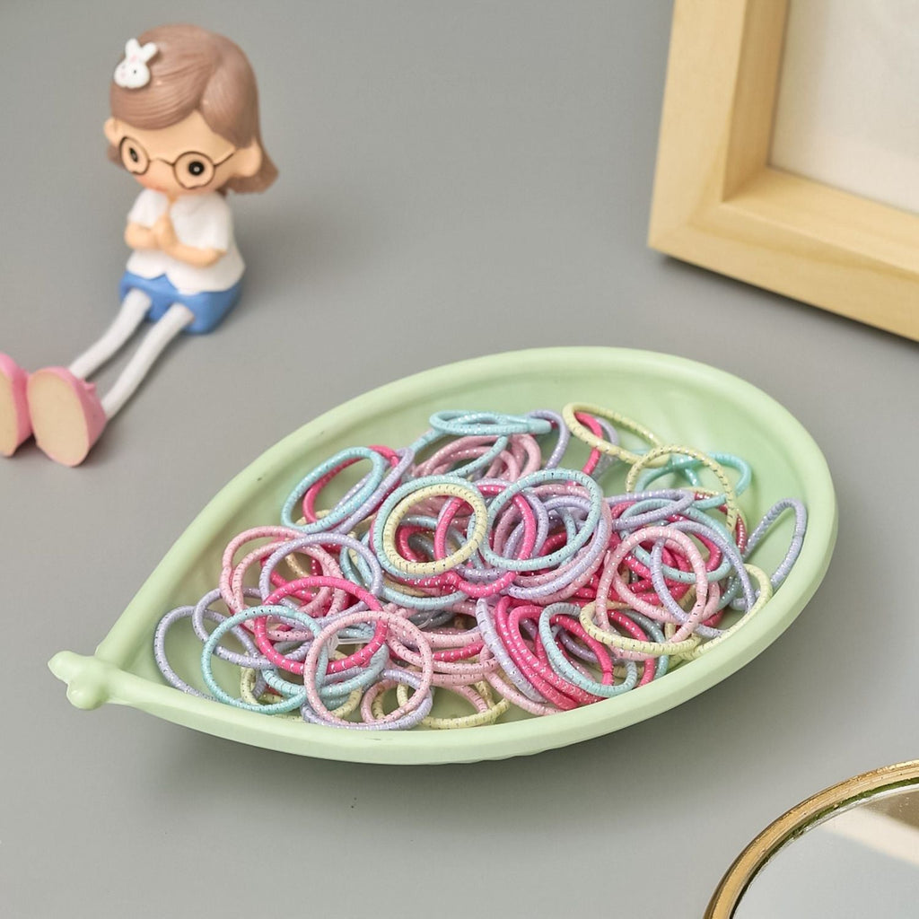 A pastel bowl filled with Yellow Bee's cute elastic rubber bands, perfect for organizing or gifting.
